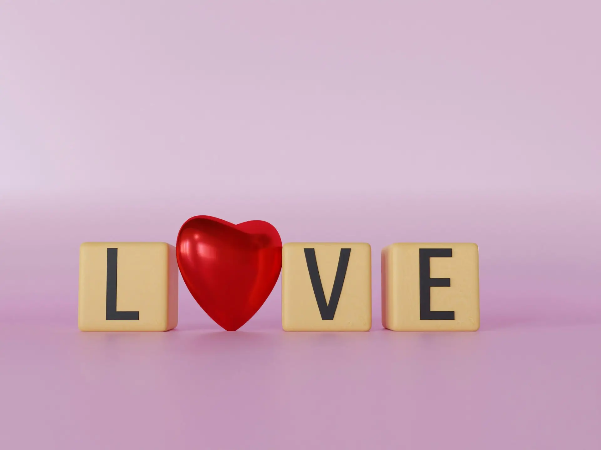 a wooden block spelling love with a red heart